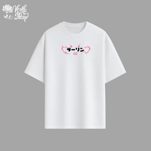 White t-shirt with pink and black graphics on a gray background
